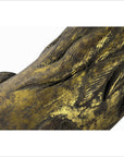 Close-up of gold and dark brown carved wood sculpture with crackled lion-like details.