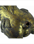 Close-up of a gold-painted, hand-carved Indonesian beast sculpture with cracks and missing tail.