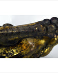 Close-up of brown wood carved Indonesian beast figurine in used condition, showing raised paw and textured fur.