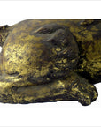 Gold and black hand carved wood beast sculpture in sleeping pose, missing tail, shown against neutral background.