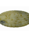 Close-up of round pale jade medallion with hand-carved floral design, 2 1/8" diameter, in very good condition.