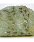 Close-up of translucent jade medallion with intricate hand-carved cut-outs, very good condition, 2 1/4" x 1 3/4" x 1/8".