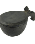 Dark wood mortar with round shape, hinged lid, and spout-like handle shown on one side.