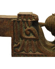 Close-up of brown teak wood architectural element with intricate carved patterns and decorative motifs.