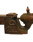 Brown teak wood architectural element, close-up of ornate floral and leaf carvings with bulbous end finial.