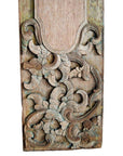 Brown wood rectangular wall plaque with hand-carved swirling floral and leaf motifs, close-up view.