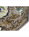 White porcelain tray close-up with gold floral motifs and painted scenes, corner detail shown.