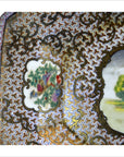 Colorful porcelain tray with gold and brown ornate patterns and floral motif, 14"x10", on neutral background.