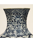 Close-up of a blue and white hand painted Chinese porcelain vase with floral and geometric patterns.