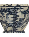 Blue and white porcelain vase with hand-painted pine trees, cranes, and clouds, close-up view.