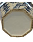 Blue and white porcelain vase with octagonal base, close-up showing decorative side motifs.