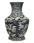 Blue and white porcelain vase with hand painted floral motifs, trees, and cloud designs, close-up.