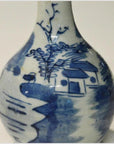 Blue and white ceramic vase with hand-painted Chinese landscape, featuring house, trees, and water, close-up view.