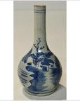 Blue and white hand painted ceramic vase with long neck, featuring house and river scene, close-up view.