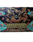 Black lacquer hand painted dowry box with gold dragon and colorful floral designs, close-up view.