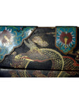 Black wooden dowry box with hand-painted gold dragons and teal floral panels, close-up view.