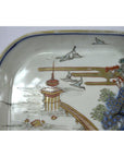 Blue and white porcelain Imari bowl with hand painted landscape featuring pagoda, birds, trees, bridge.