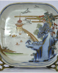 Multicolor porcelain Imari bowl with hand painted Asian landscape, figure, trees, birds, and pagoda by water.