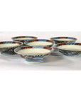Blue, red, and gold porcelain Imari small plates set of 6 displayed on a white surface.