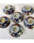 Blue, red, and gold hand painted Imari porcelain small plates set of 6, displayed on white background.