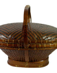 Natural rattan hand woven basket with handle, lid, and zigzag patterns, close-up view.
