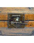 Close-up of brown lacquered hinged Chinese box with iron hardware and central metal latch.