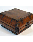 Close-up of vintage brown lacquer Chinese box with iron hardware and latch, closed on a white background.