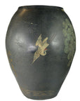 Black ceramic vase with crackled finish, light paint loss, and a painted crane among green foliage.