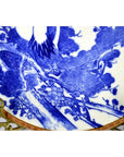 Blue and white Igezara transferware plate with tree and bird motif on ornate gold stand, Meiji period, close-up.