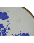 Close-up of blue and white ceramic Igezara Transferware plate with brown rim on a white background.