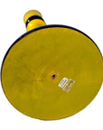 Yellow folk art candlestick with circular base, small hole, worn label, close-up on white background.