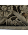 Brown carved wood plaque with flower and leaf design, rectangular, shown against a plain background.