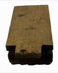 Brown wood hand carved India temple plaque, rectangular with notched end, close-up on white background.