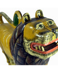 Brown painted wooden lion figurine with carved details, loose joints, open mouth, and wide eyes, close-up view.