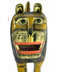 Brown painted wood hand-carved lion with green eyes, black stripes, and open mouth, close-up, good condition.