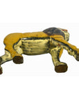 Brown wooden carved lion with loose joints lying on its side, white background.