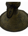 Close-up of an Indian brass oil burner showing intricate patterns and a raised, pointed center.