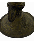Close-up of an Indian brass oil burner showing intricate patterns and a raised, pointed center.