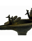 Close-up of brass Indian oil burner with bird-shaped decorations, 5 1/4" diameter, on white background.