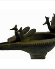 Close-up of brass Indian oil burner with bird-shaped decorations, 5 1/4" diameter, on white background.