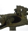 Close-up of a brass Indian oil burner with bird and fan designs on top, 5 1/4 inch diameter.