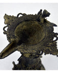 Ornate brass Indian oil burner with intricate details, spout on one side, vase-like design, top view.