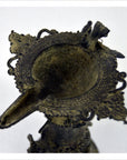 Ornate brass Indian oil burner with intricate details, spout on one side, vase-like design, top view.