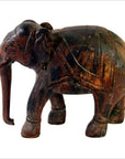 Brown wooden Indian elephant carving with raised trunk, detailed features, close-up view, good condition.