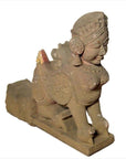 Gray stone Indian 19th-century hand-carved sphinx sculpture with tiara and earrings, animal body, close-up view.