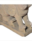 Gray stone 19th-century Indian sphinx sculpture with tiara and earrings, close-up on intricate carved details.