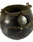 Close-up of a round, weathered iron water jug with ring handle, vintage metal vase, 7-inch size.