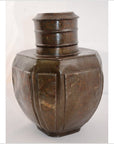 Silver metal octagonal Indian water jug with a round, decorated neck and engraved patterns, close-up.