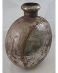 Rustic metal oval Indian water jug, close-up, antique-style finish, photographed as home decor accent.