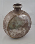 Silver metal Indian water jug with oval shape, short neck, and visible weld marks on plain background.
